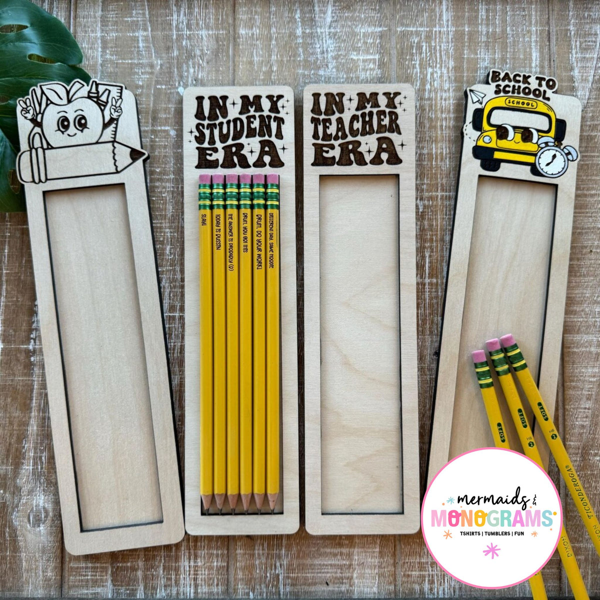 Pensils in wooden holders with 'Back to School' theme on a wooden surface