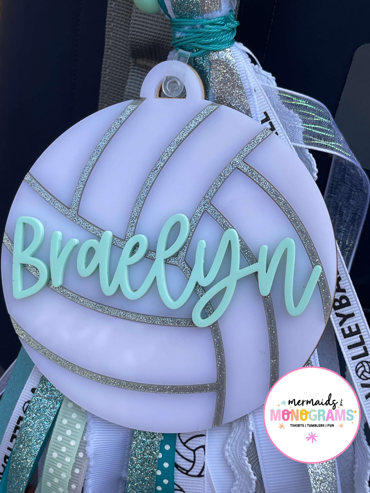 Decorative item with 'Braelynn' on a white background, featuring ribbons 