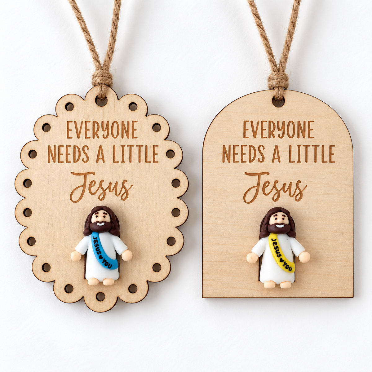 Two Everyone Needs a Little Jesus wooden ornaments with mini Jesus embellishments and twine hangers